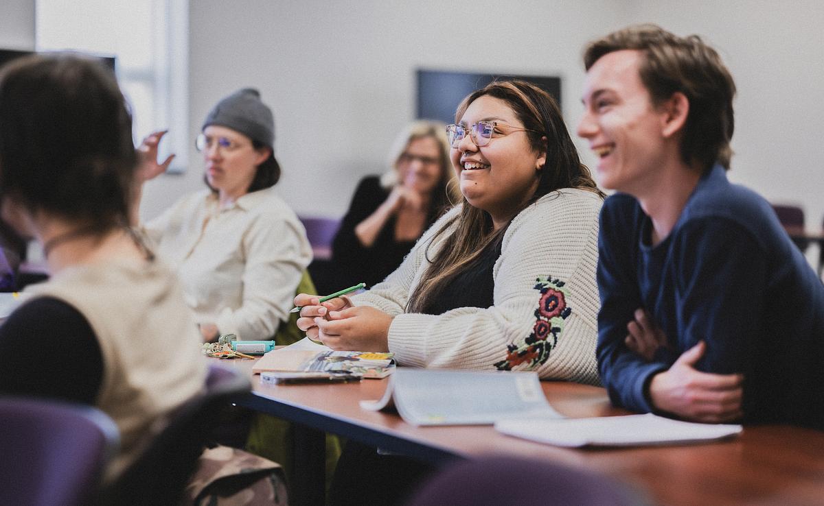 Students smiling and participating in class discussion