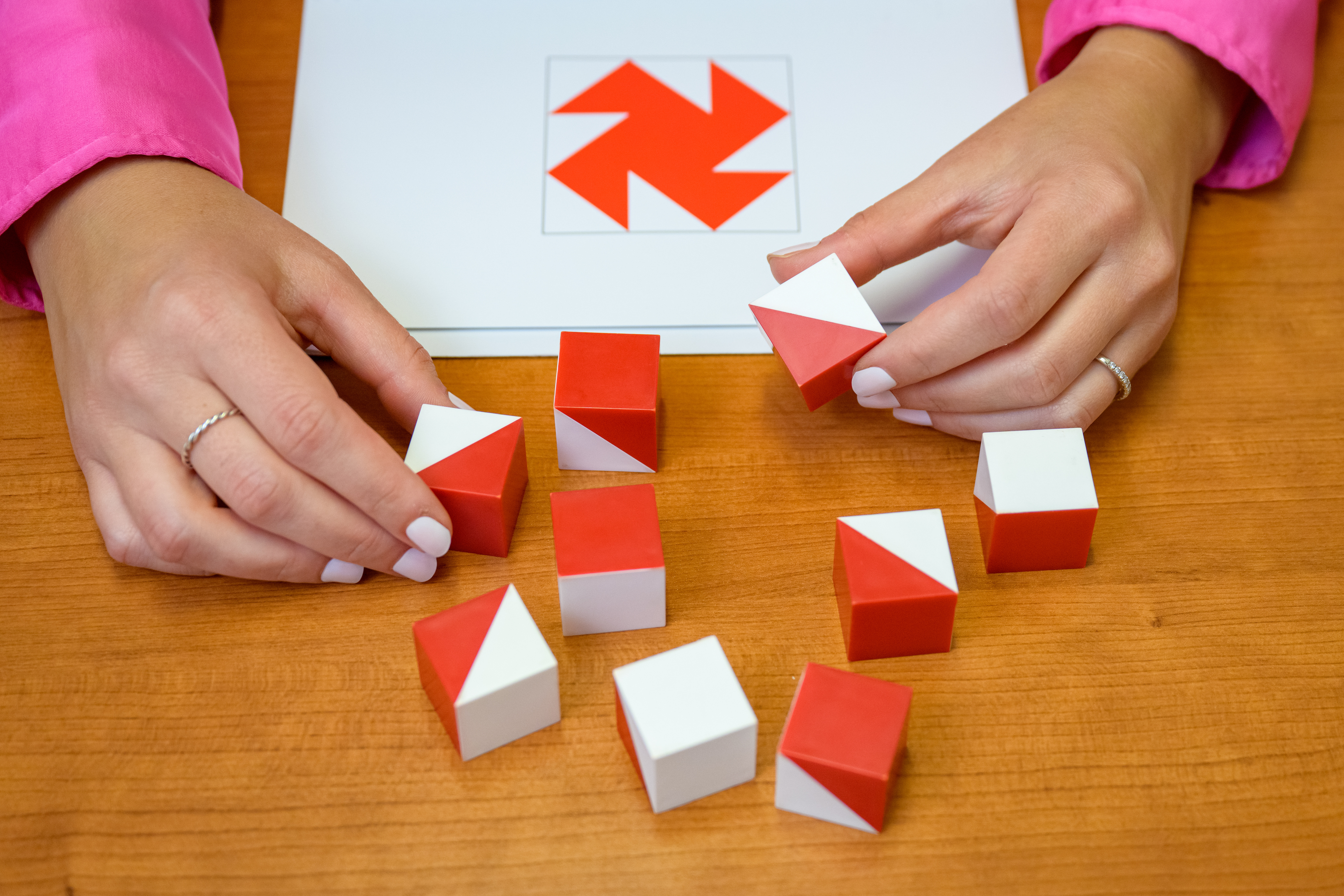 Alyssa Raggio working with psychology tools at a table