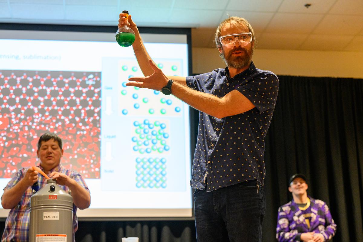 Professor demonstrating a science project in front of a class of students 