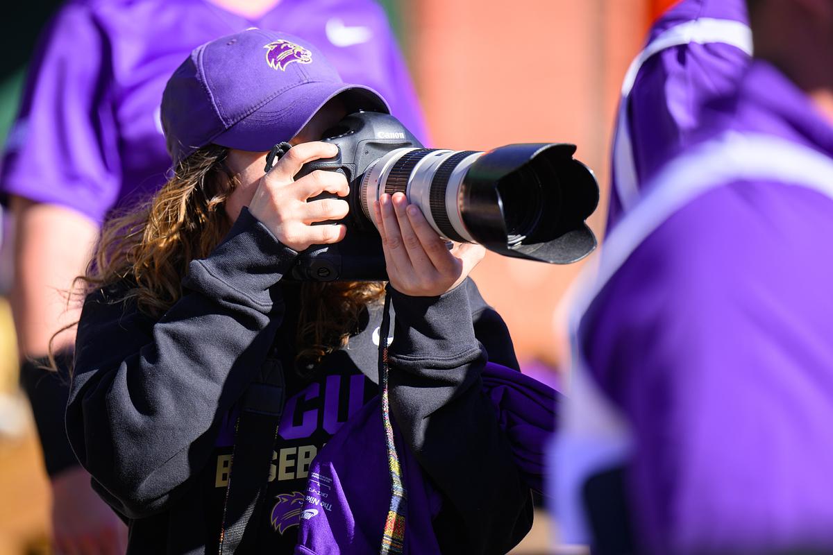 Student taking photos at a football game 
