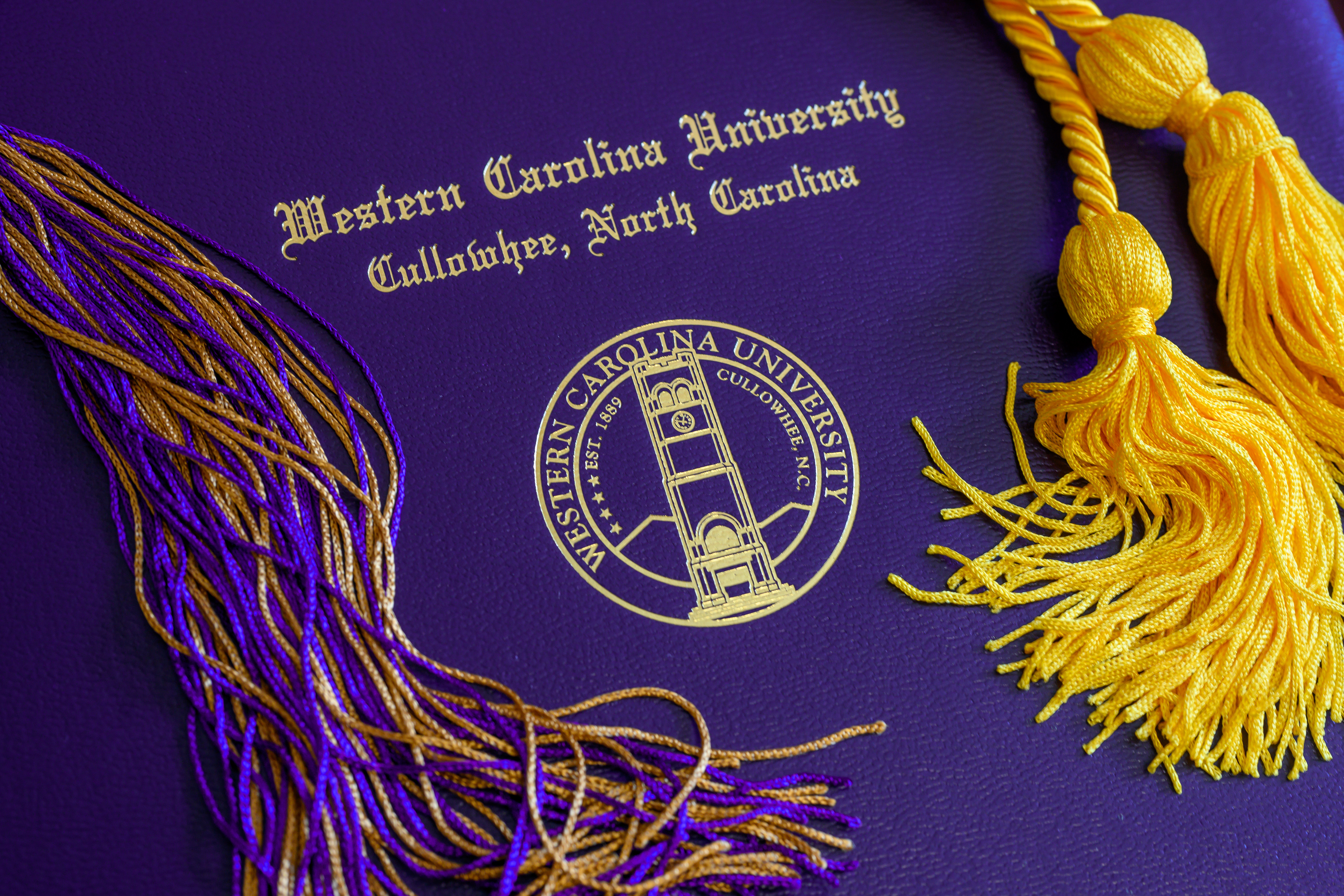 WCU diploma cover with tassel and cords