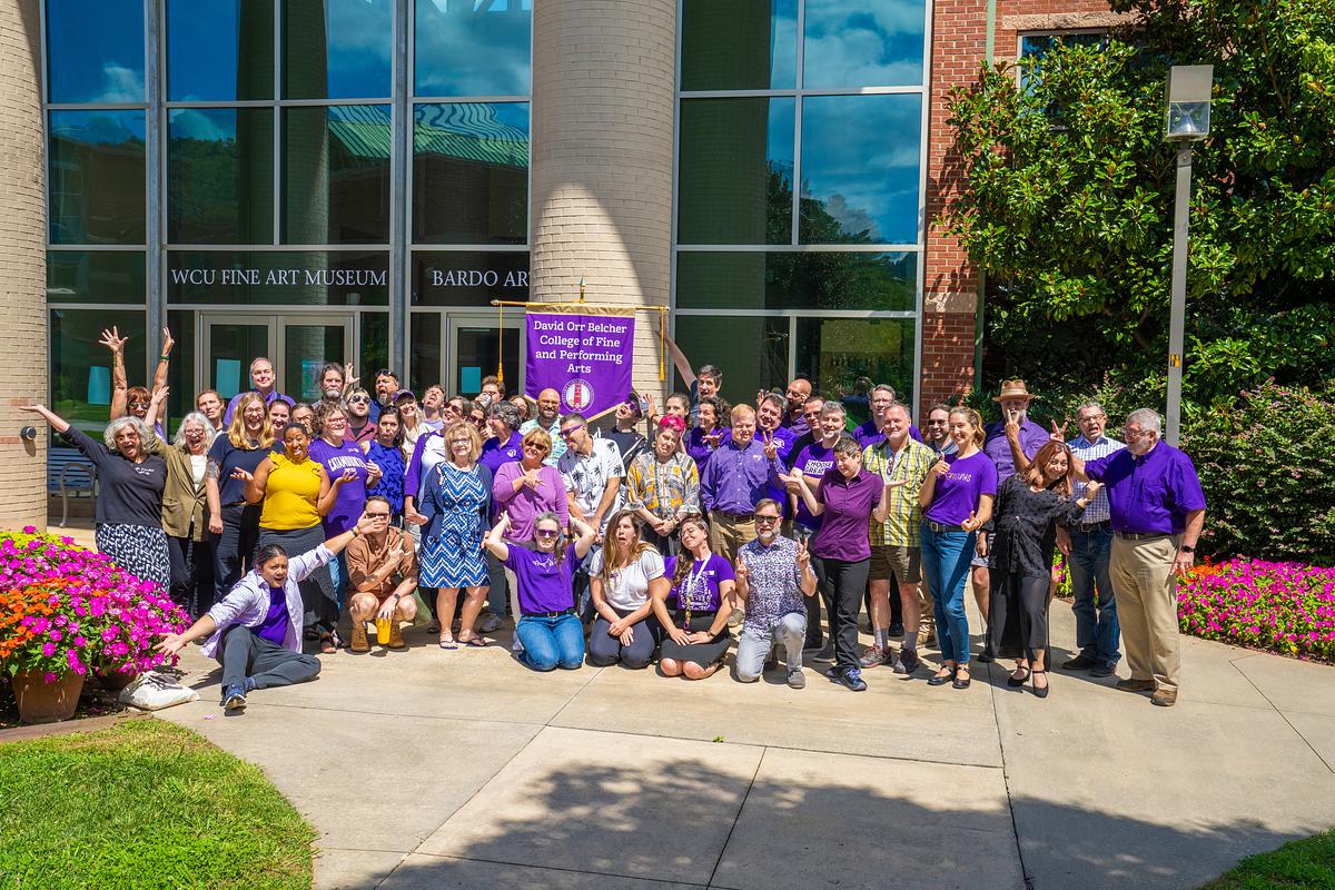 CFPA faculty pose for a group photo outside of the performing arts center