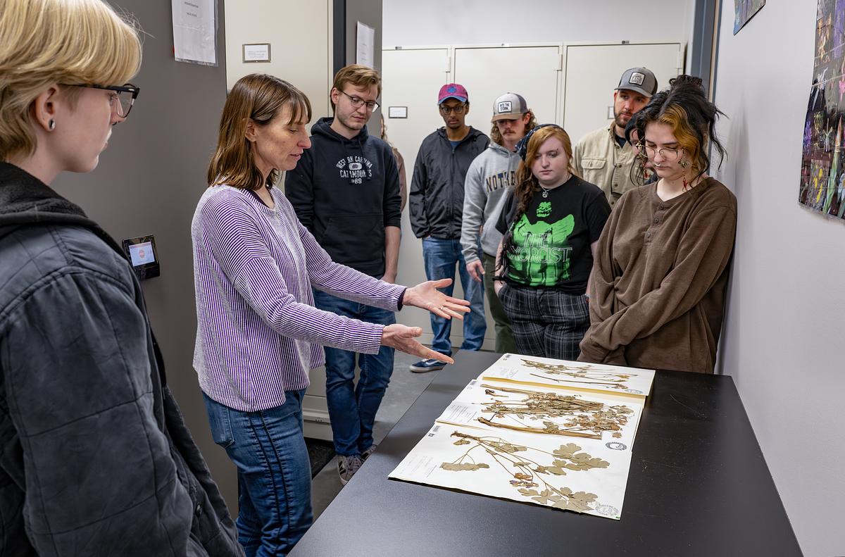 Dr. Mathews describes an herbarium specimen to a group of students.