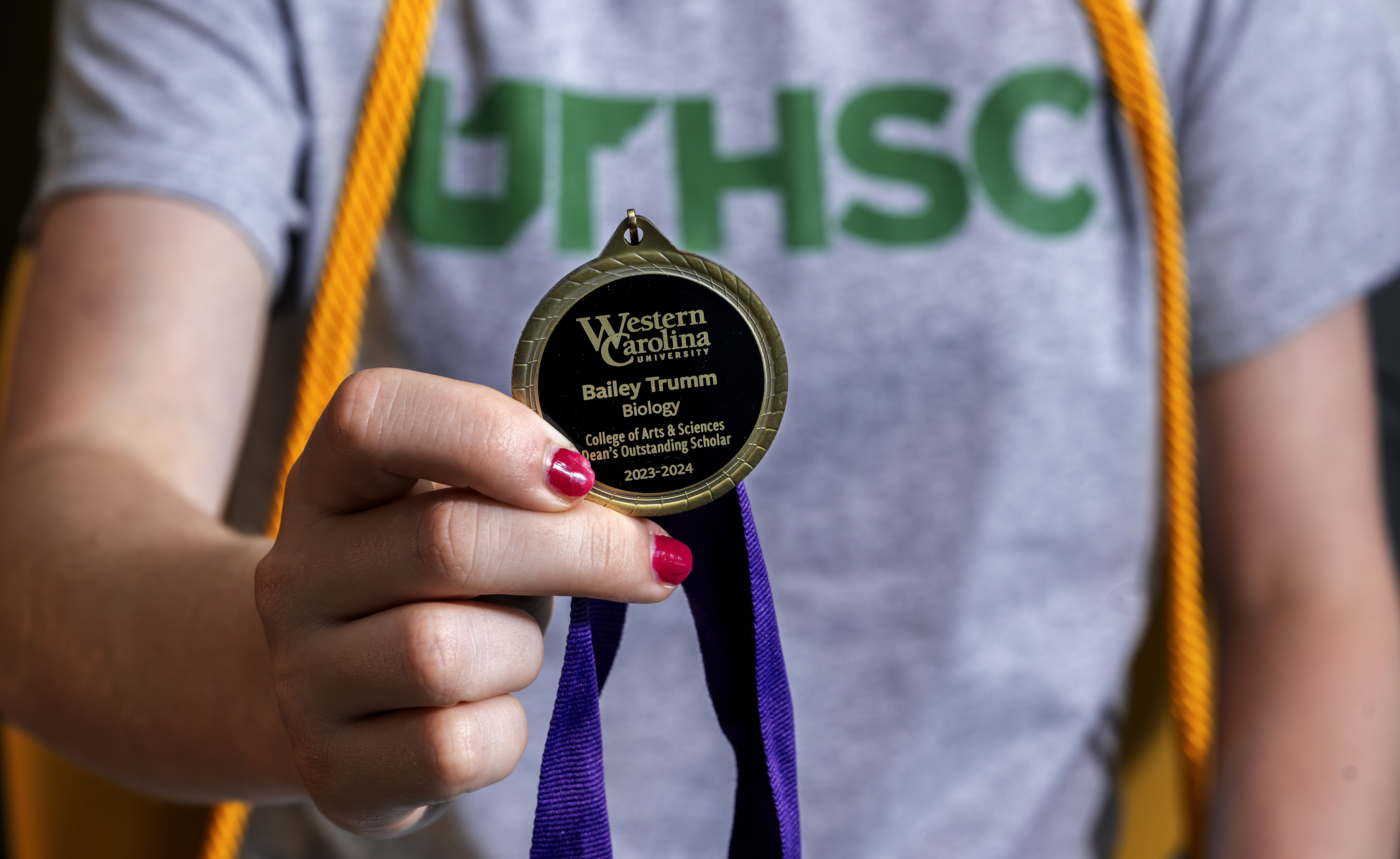 Bailey shows off her medal she received from WCU's biology department