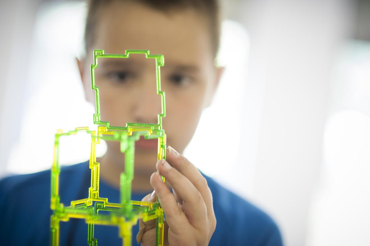 Young student working with building tools for a creative thinking and problem solving task