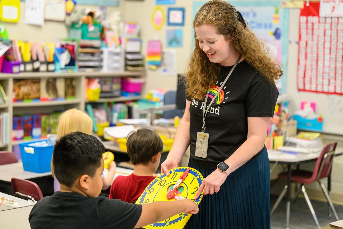 Teacher intern helping a young student in class