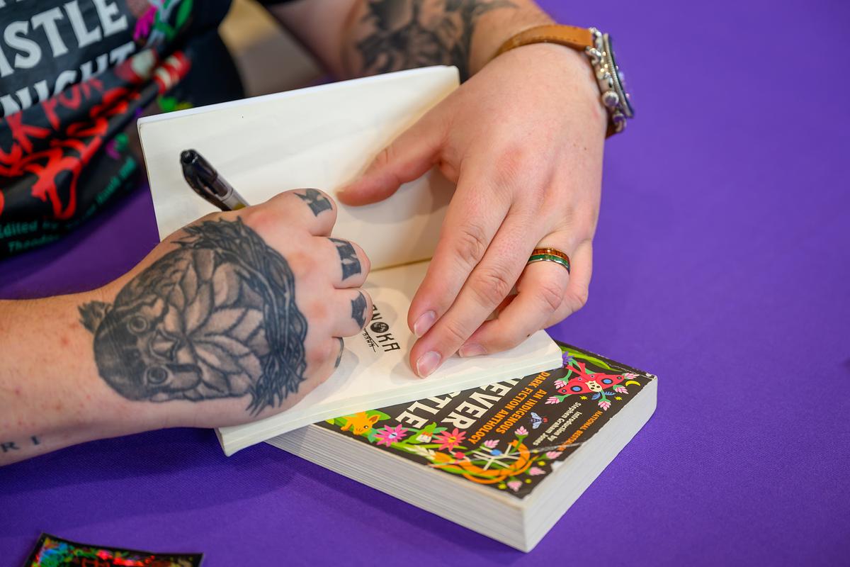 Shane Hawk signing a book