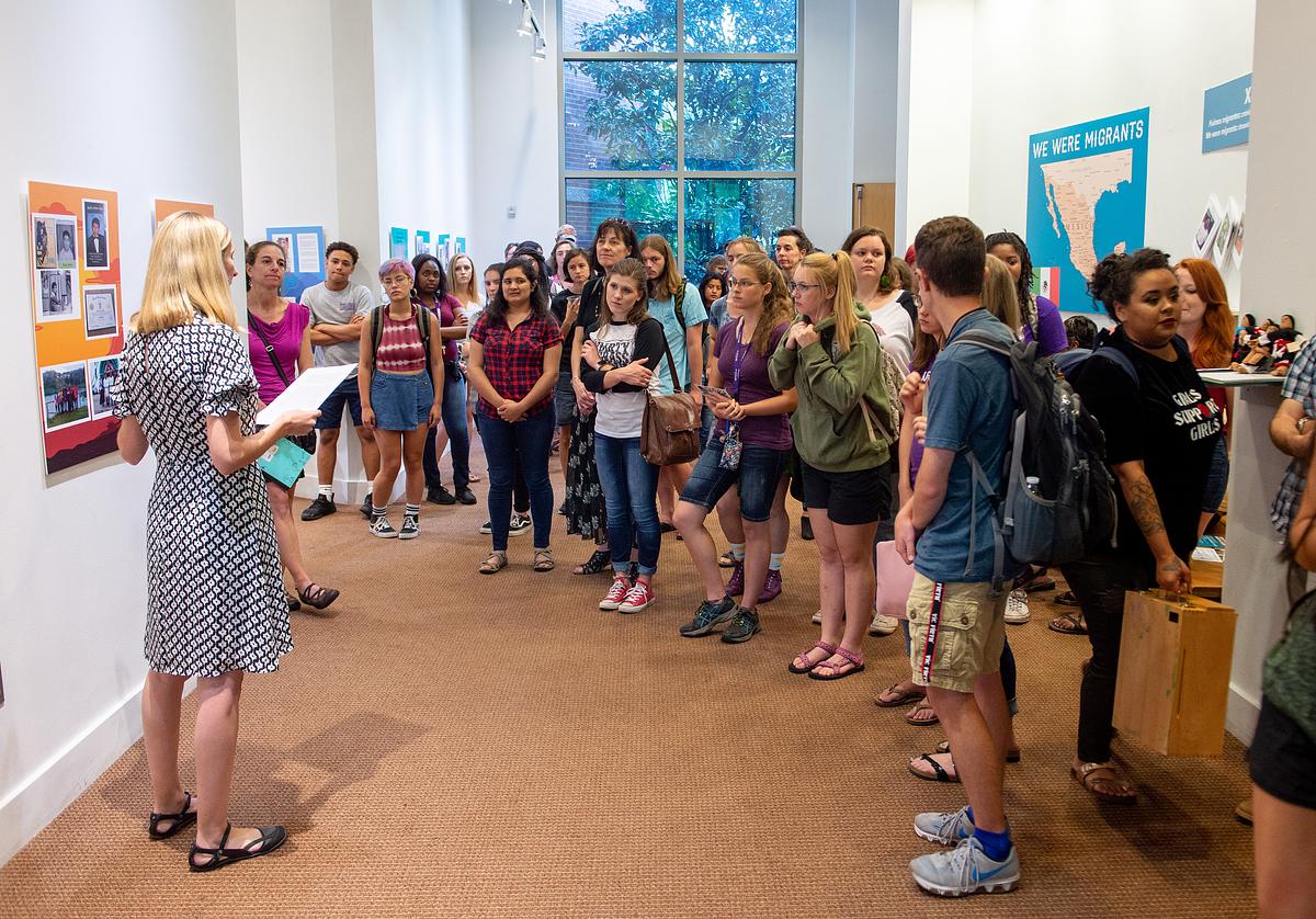 Defining America participants listening to a speech in the gallery
