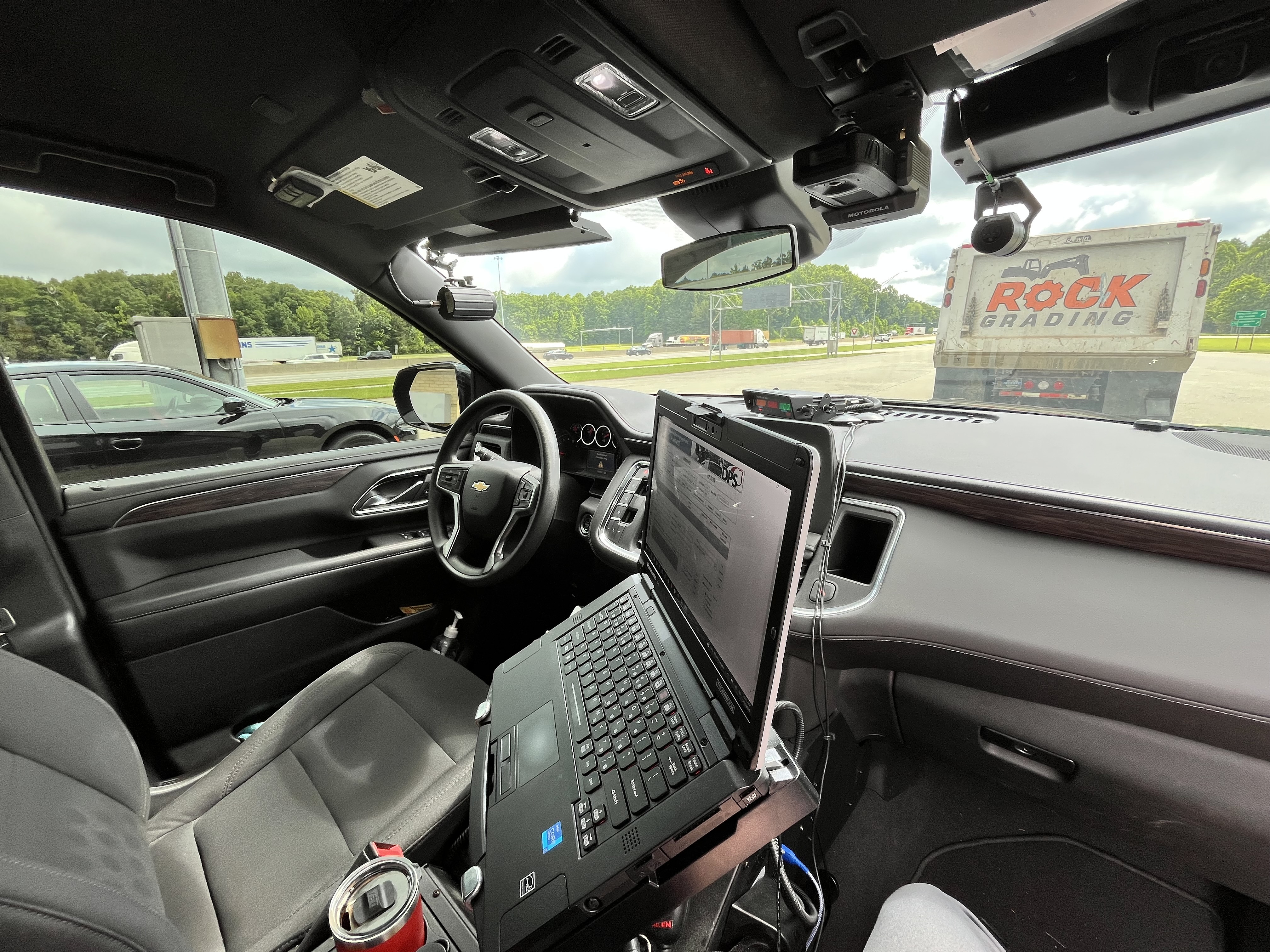 Photo of the interior of a police vehicle and dashboard equipment 