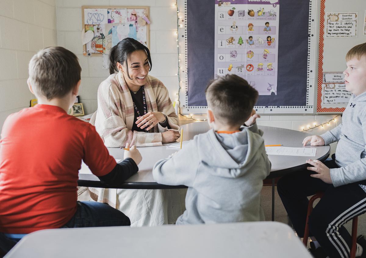Teacher working with students in class