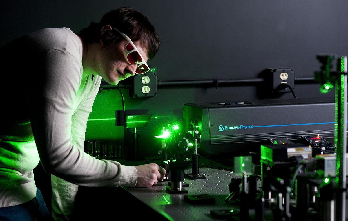 Chemistry student wearing protective eyewear working in the laser laboratory 