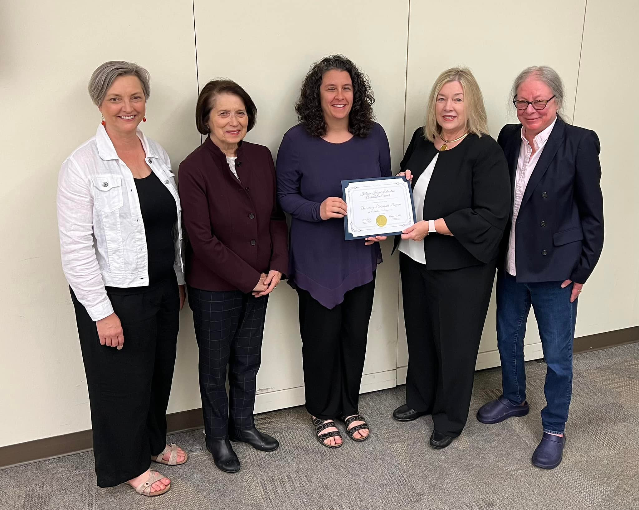 Dr. Kelley receiving accreditation certificate