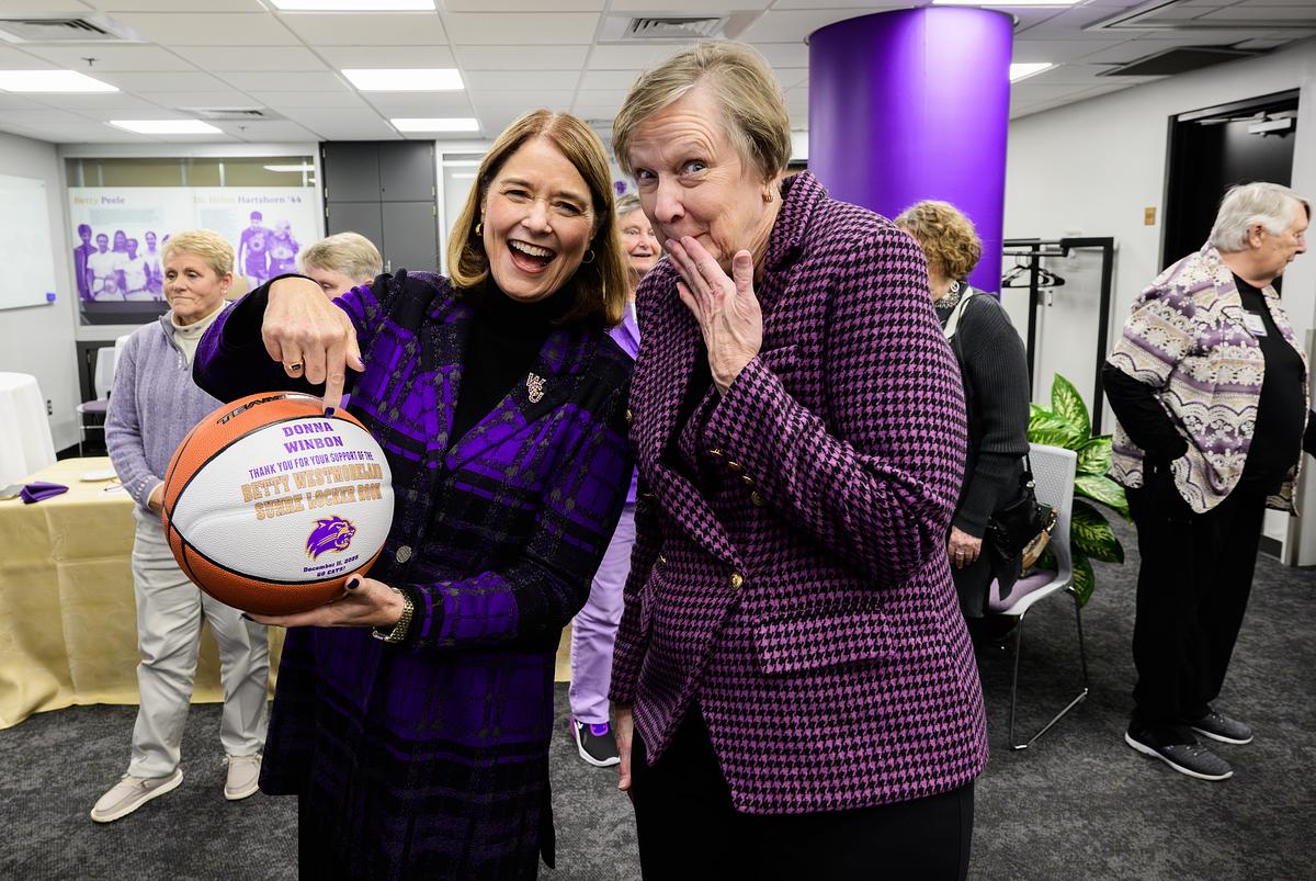 Chancellor Kelli Brown holding a basketball smiling for the camera