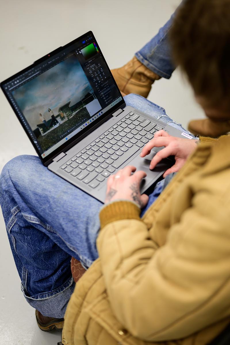 Student sitting in a chair working on their laptop