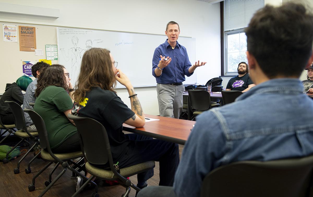 Professor animatedly gives a lecture in a Philosophy class