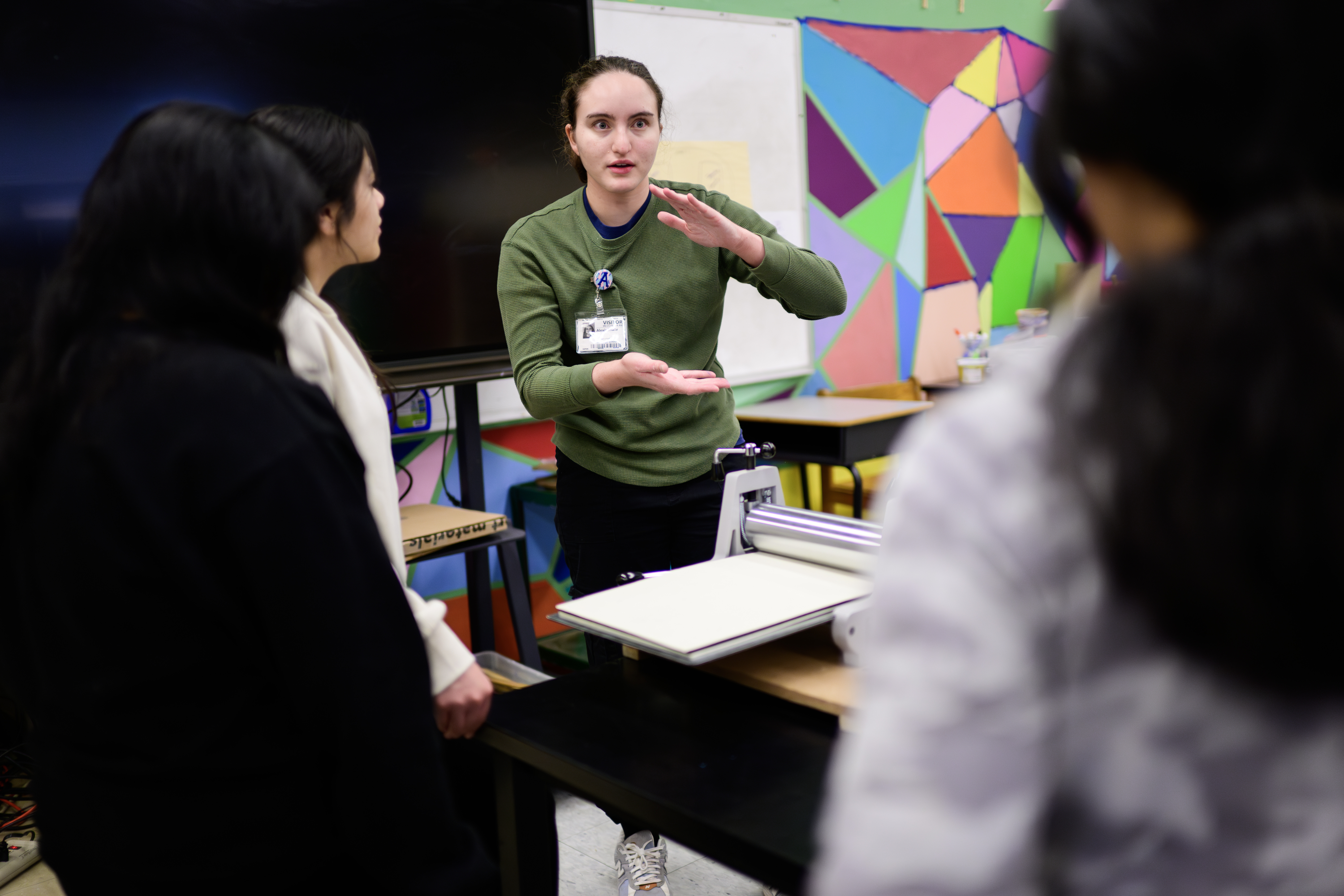 Alexis Shafir working with students on using a printing press