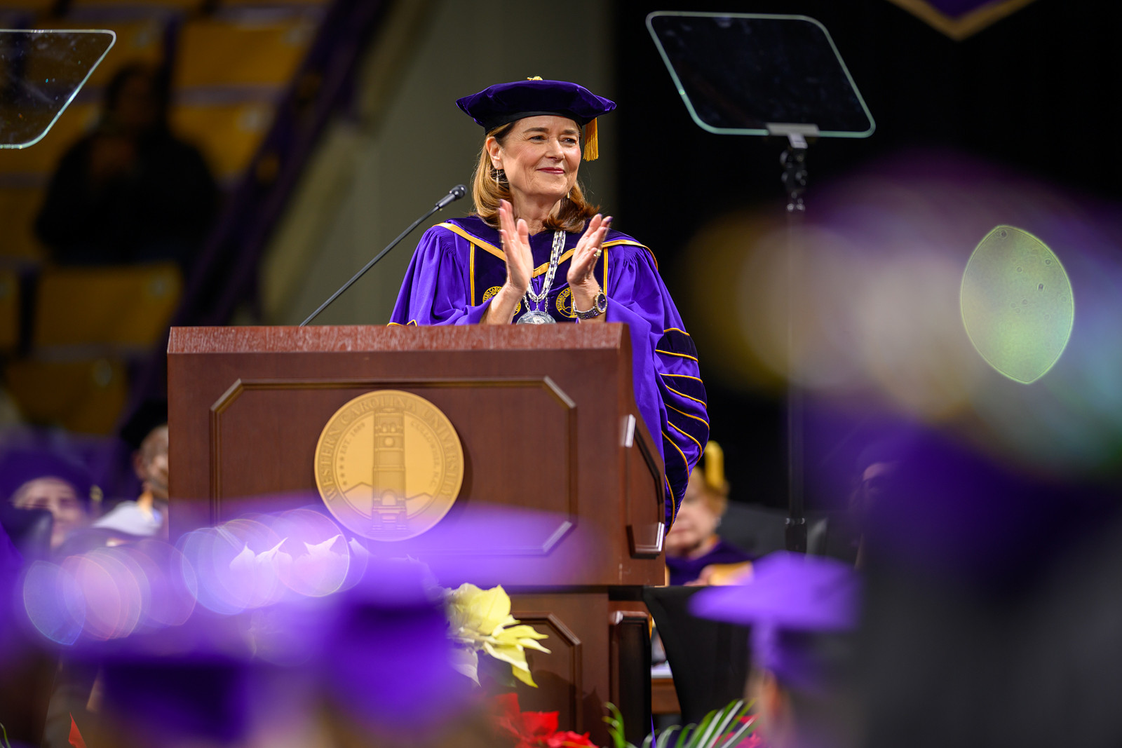 Chancellor Kelli Brown applauding with the audience during commencement