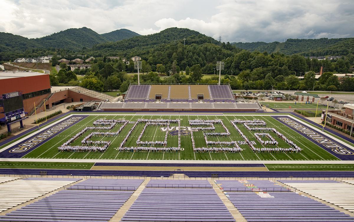 Students on the football field forming the shape of 2026