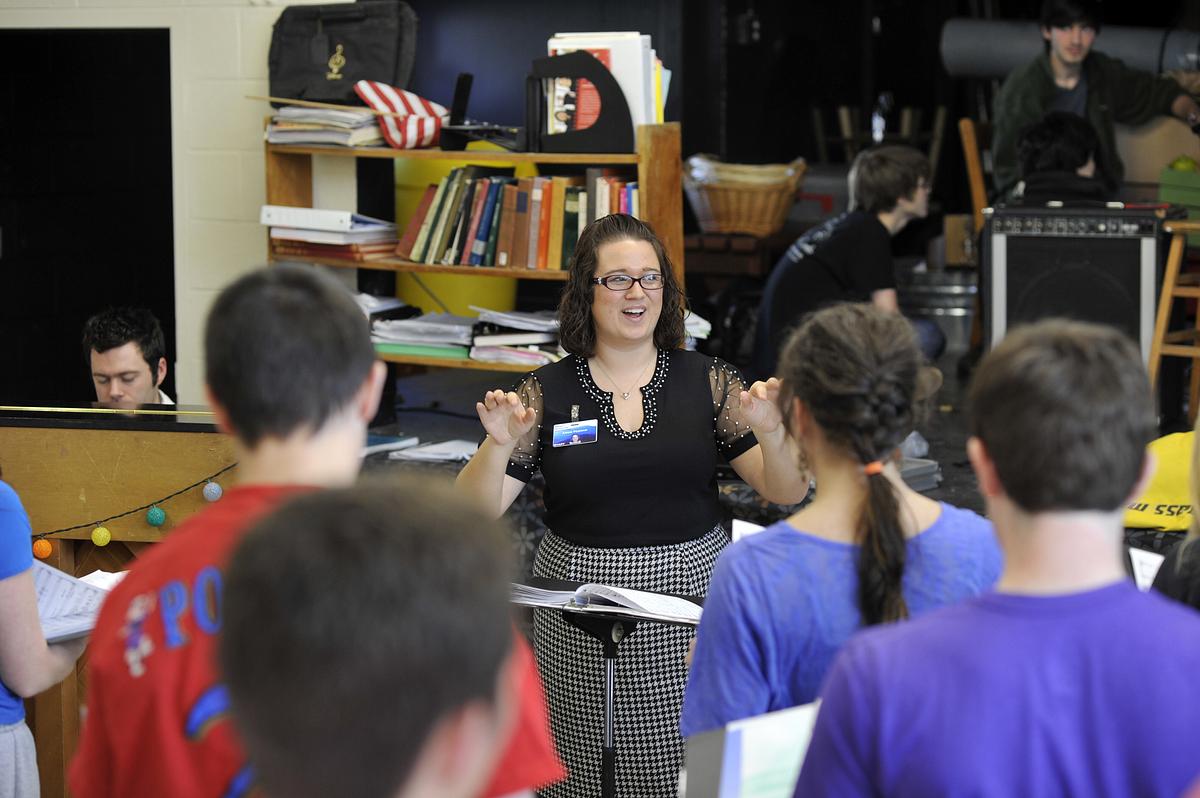 Teacher in class giving a lesson to her middle grade students