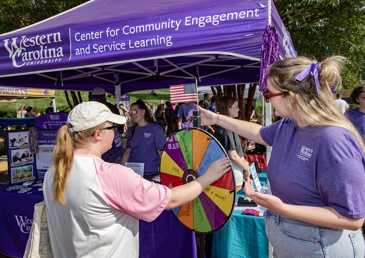 Students and faculty gathered at a booth for the Center for Community Service at the 2024 Valley Ballyhoo