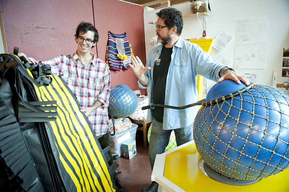 Professors discussing sculpture pieces