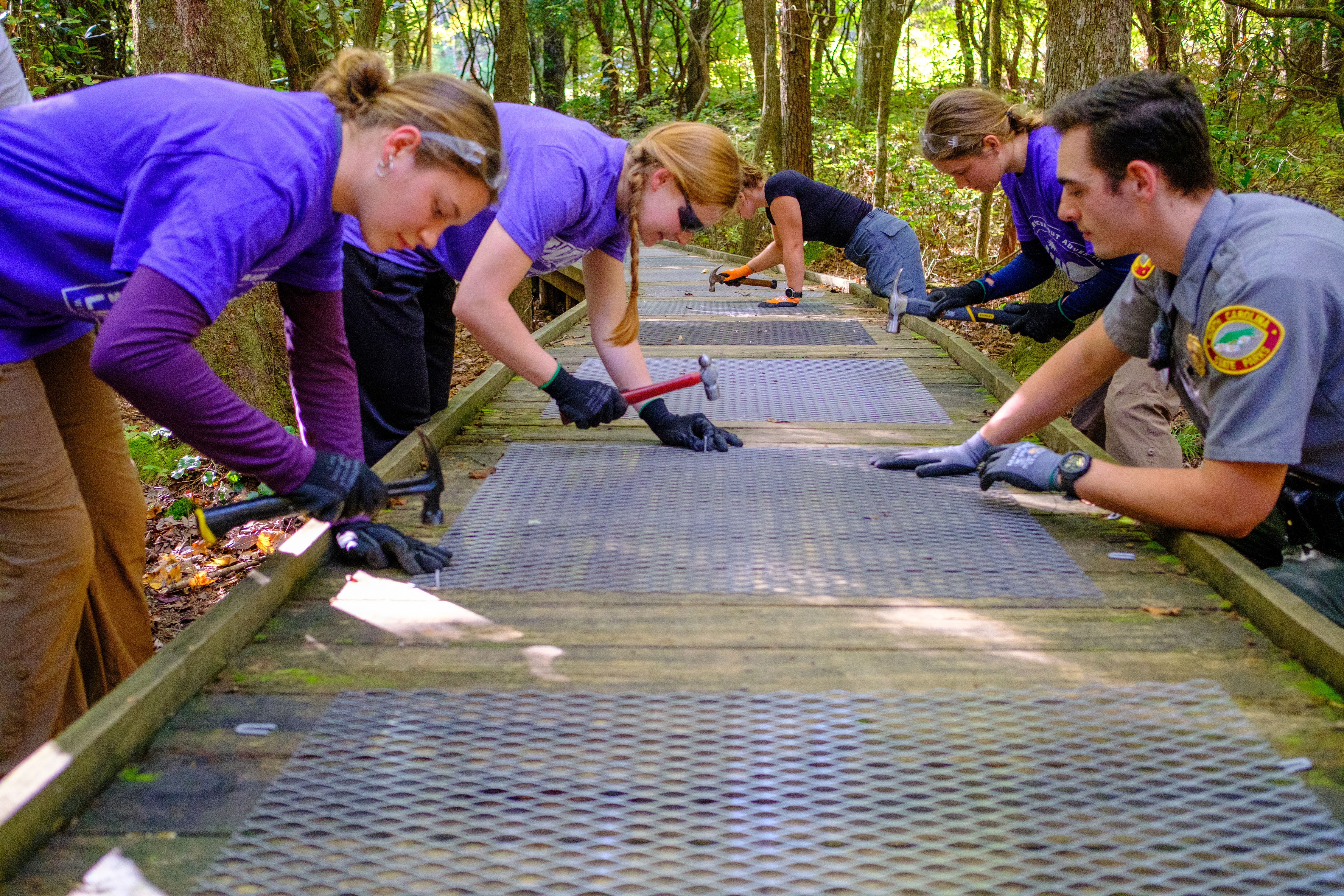 Vlog students work on repairing a walkway