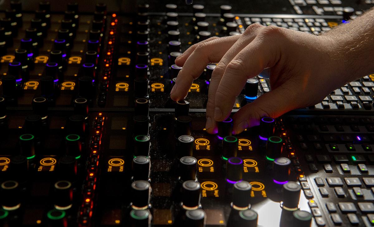 Student technicians work at a sound and video board for a production