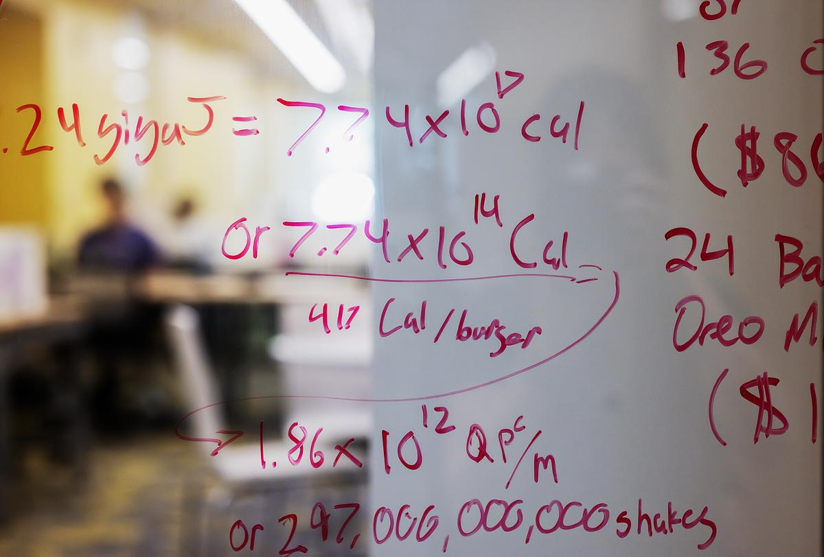 Math equations written on a glass pannel