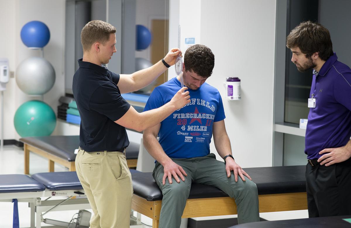 Patient being examined by physical therapy faculty and student