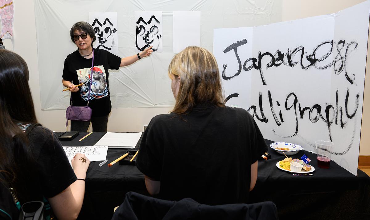 Japanese students and faculty smiling for the camera in a large group