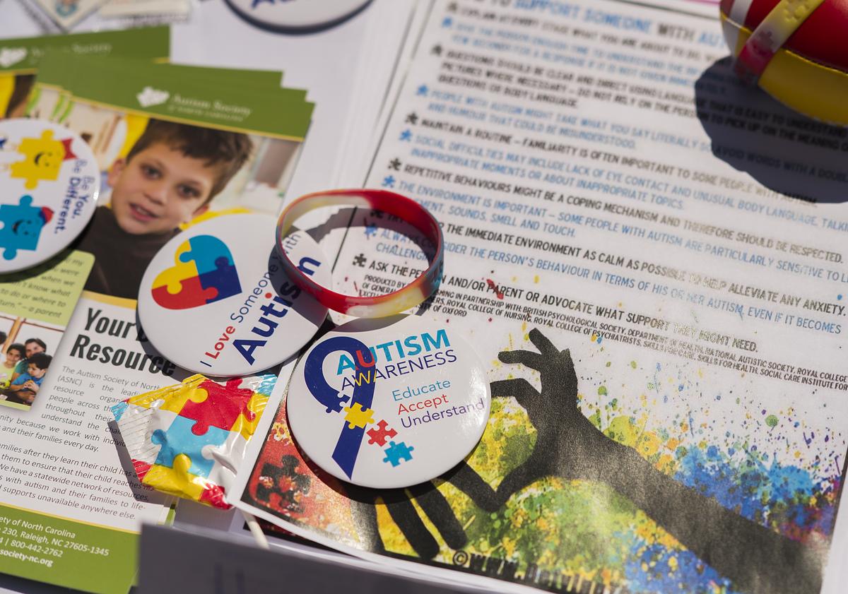 Autism support pins and documents on a table