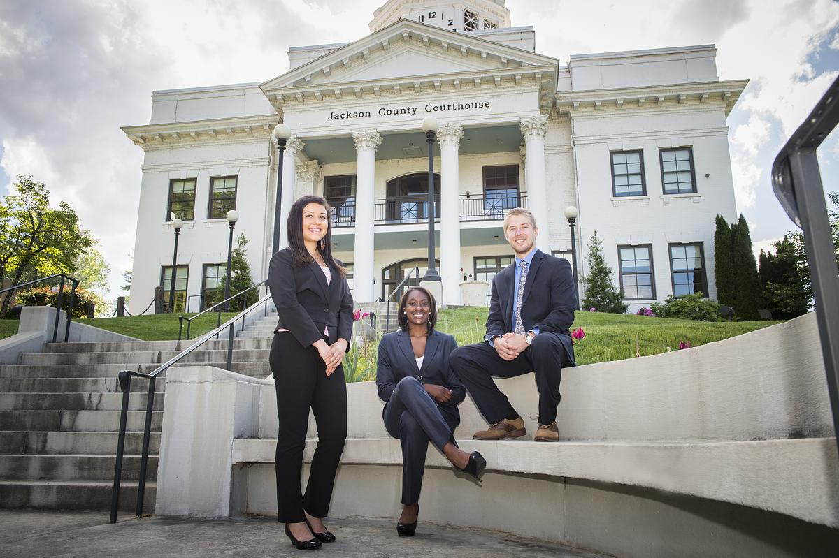 Criminal justice students together for a group photo outside of a government building