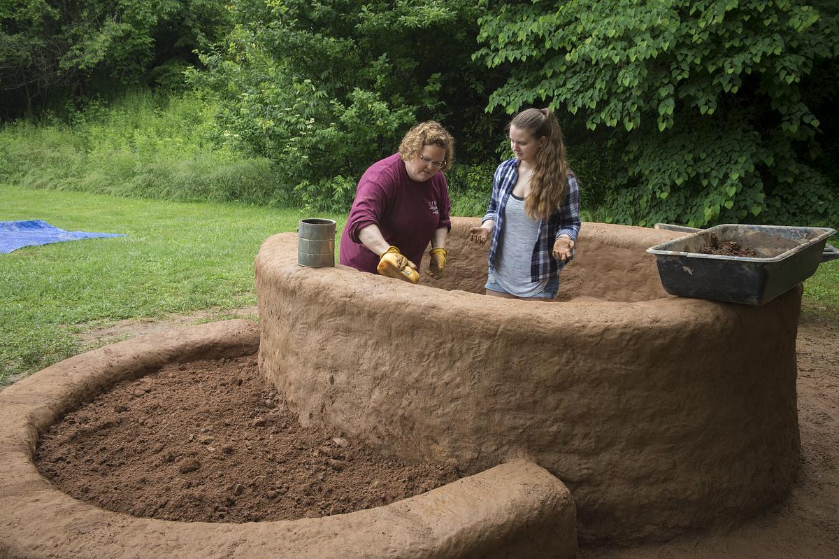 Teacher and student building a sculptured house 