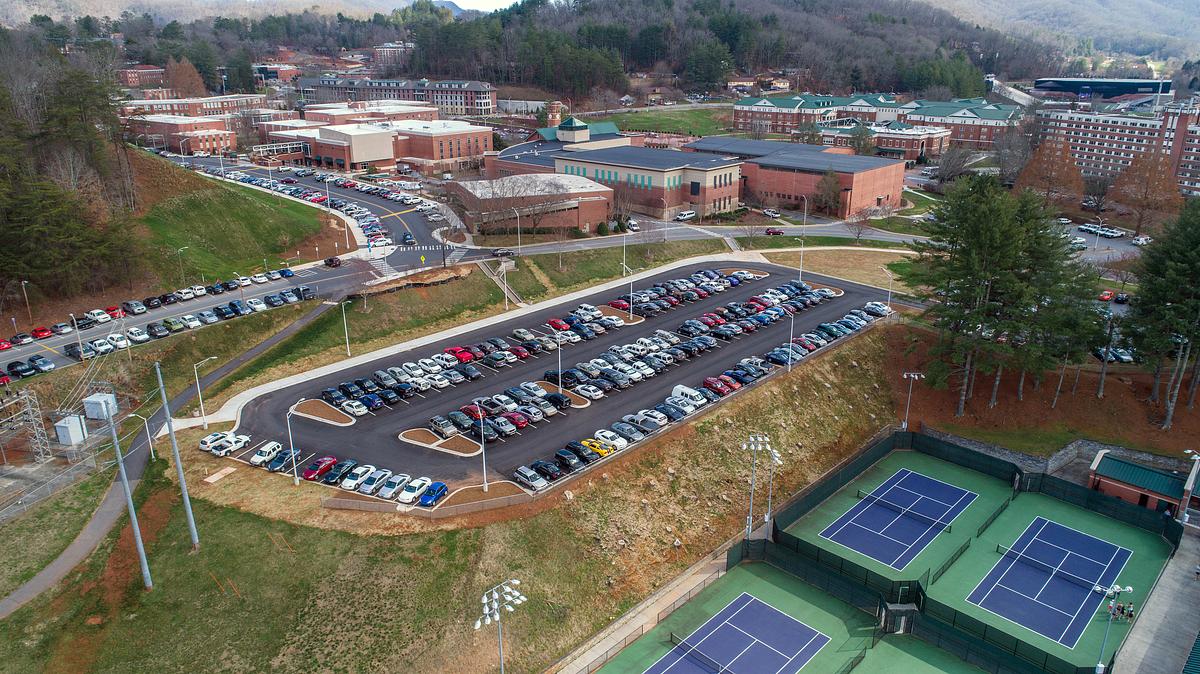 Aerial view of campus and a parking lot