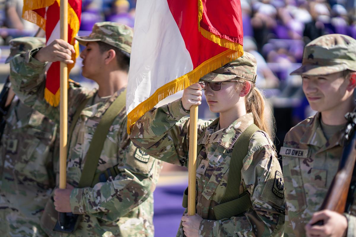 Student Soldier holding a flag holding stance