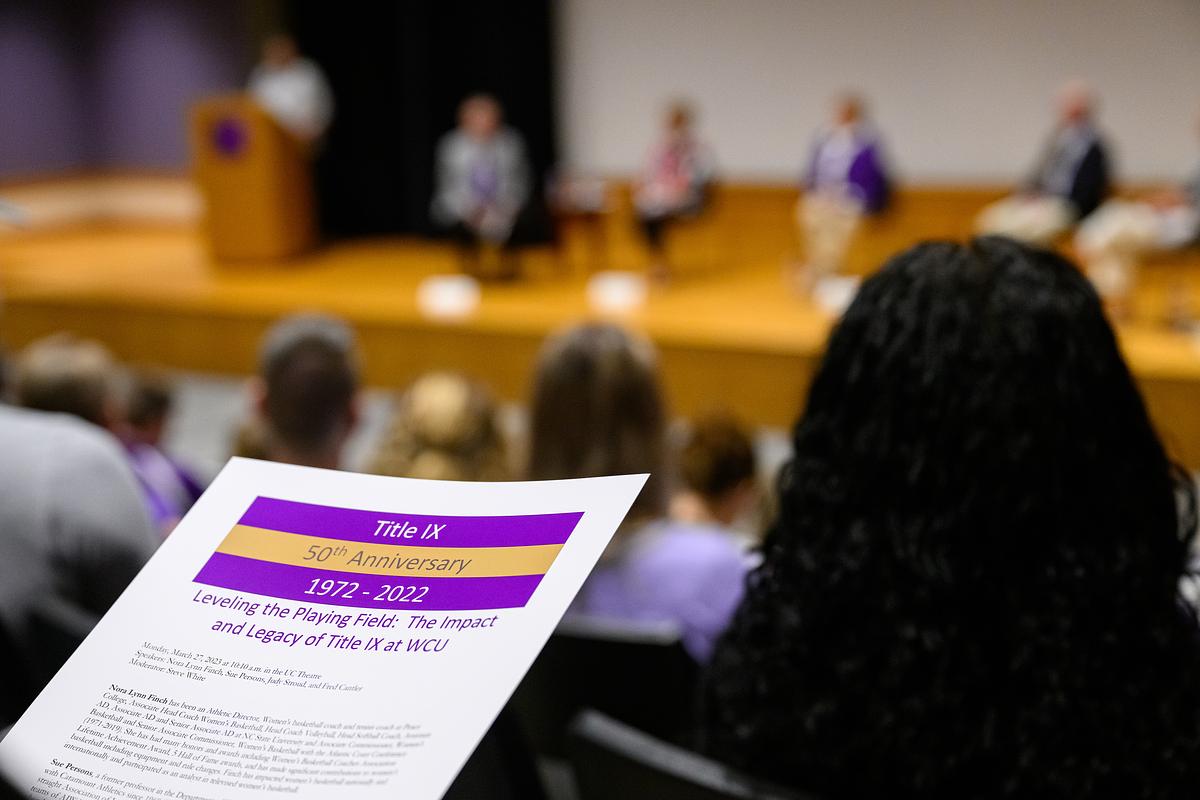 Audience members listening to a panel of members presenting for the Title IX anniversary 
