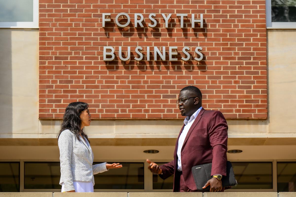 Professors talking in front of the Forsyth Building