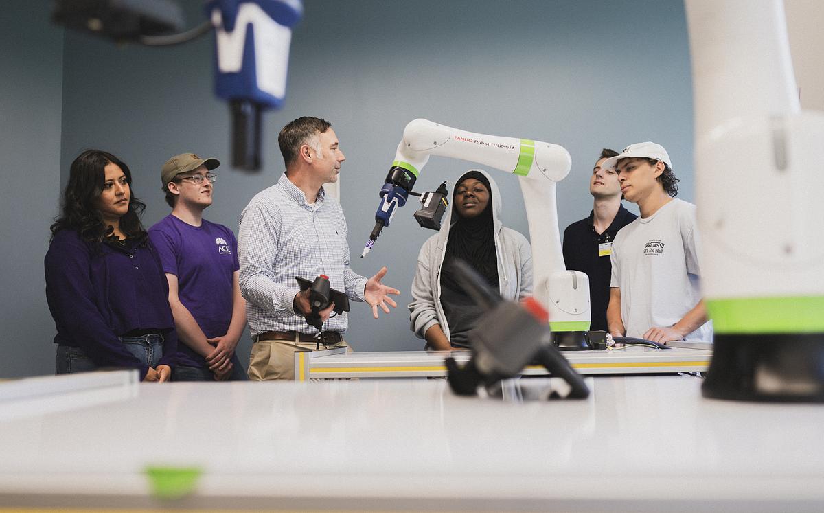 Image of Students and Faculty Member in Robotics Lab