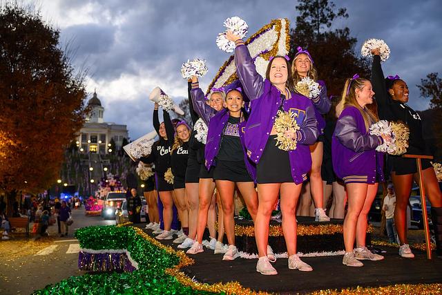 Cheerleaders stand on a float and wave during the 2025 homecoming parade in Sylva
