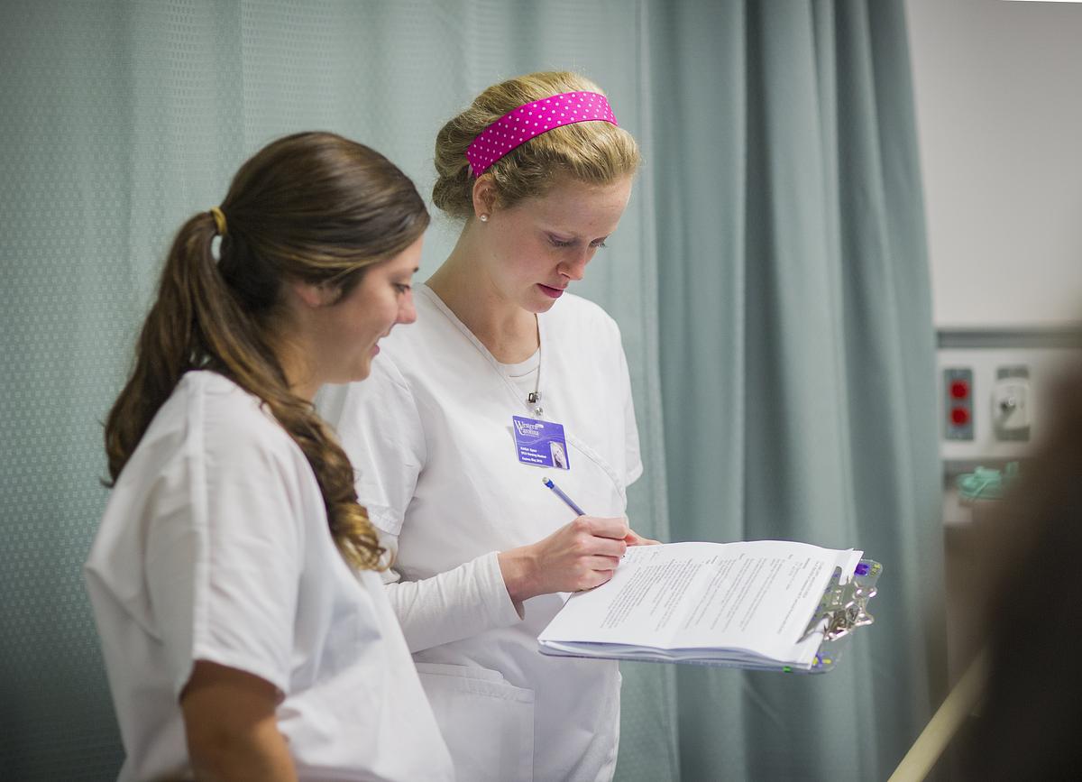 Nutrition Dietetics practitioners looking over a clipboard together