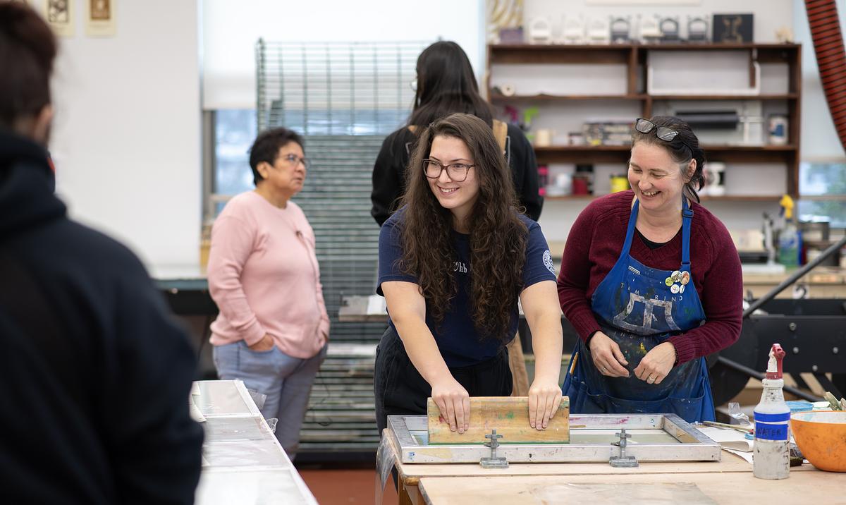Professor and student working on manual printing