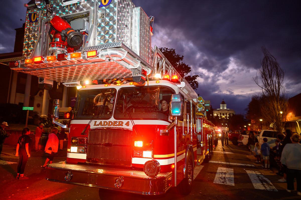 Firetruck with lights on driving down Sylva's main business district for the parade