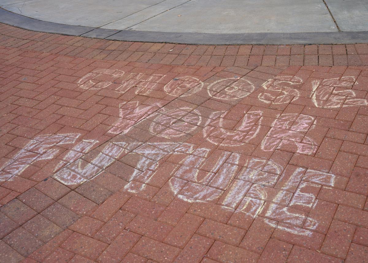 Choose your future written in chalk on a sidewalk