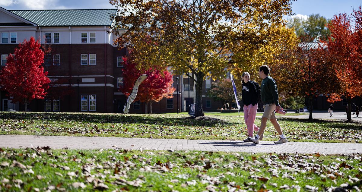 Students walking around campus on a fall day