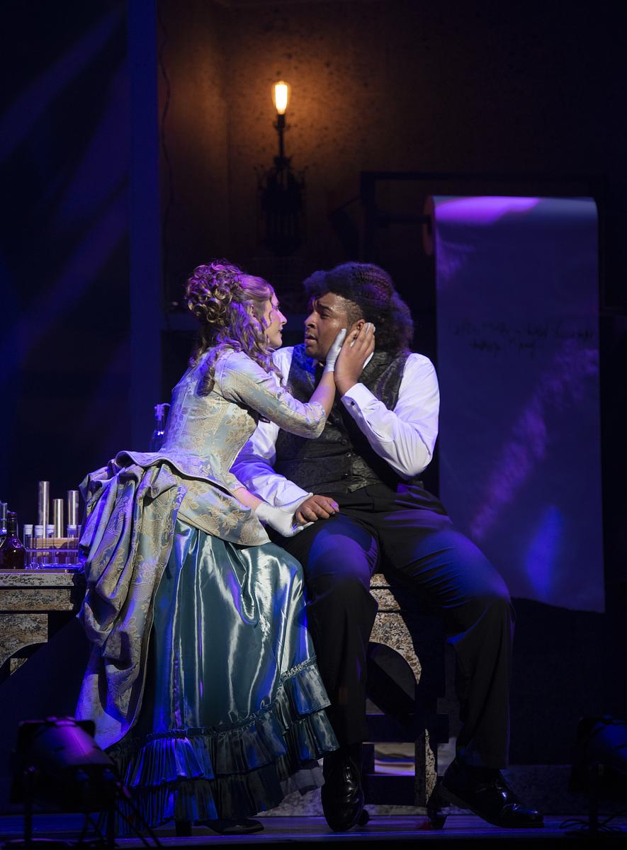 Two students acting during a live performance in dramatic fashion