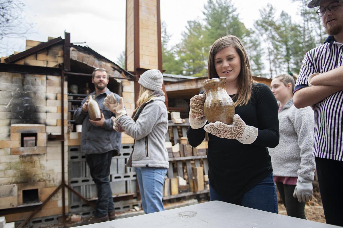 Teacher and Students unloading a fired kiln