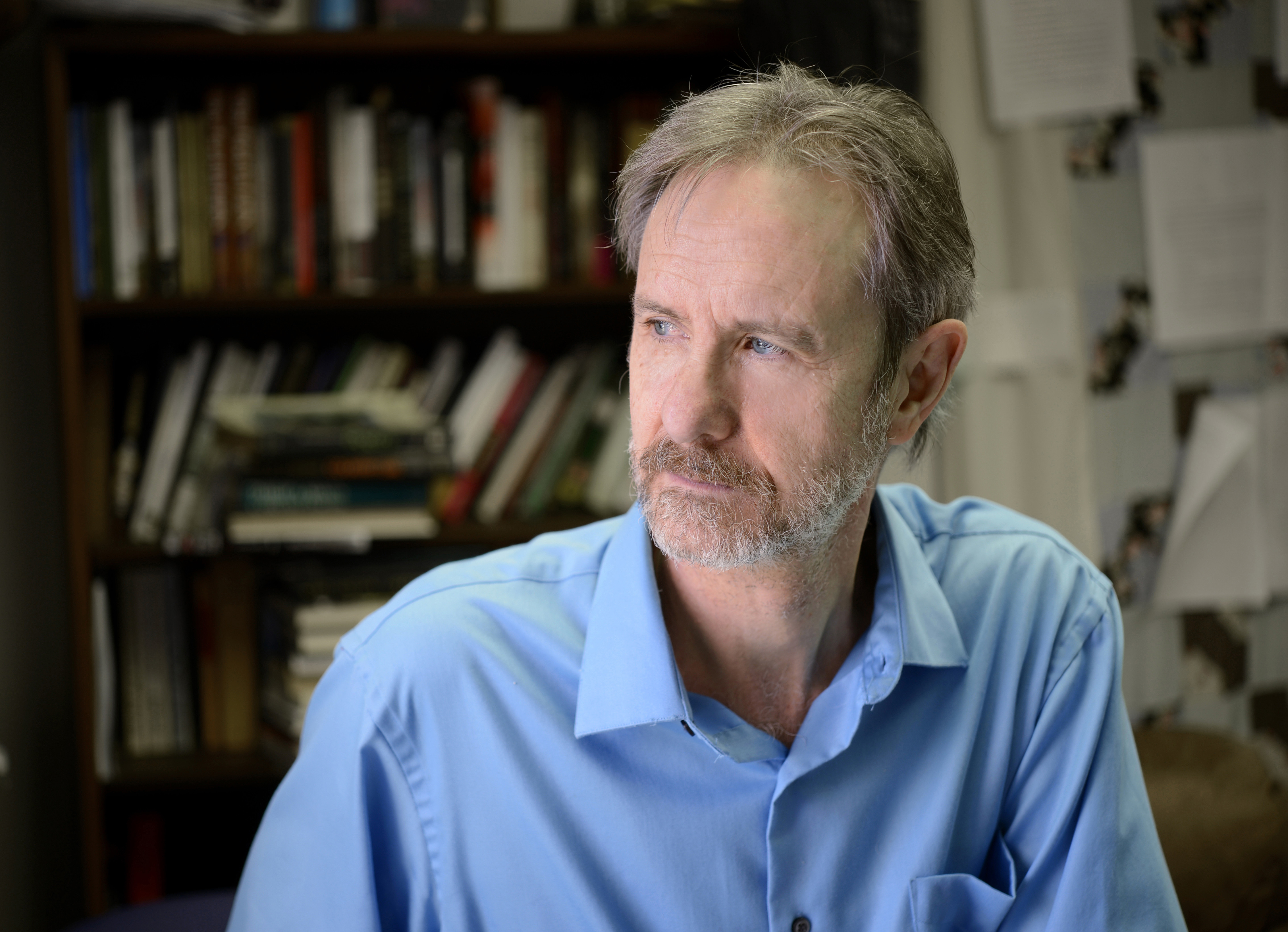 Photo of Ron Rash in an office with books in the background