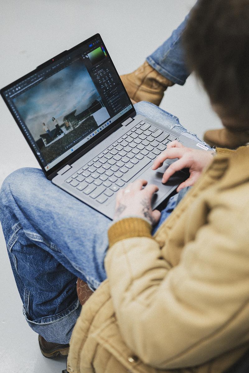 Student working on their laptop in a chair