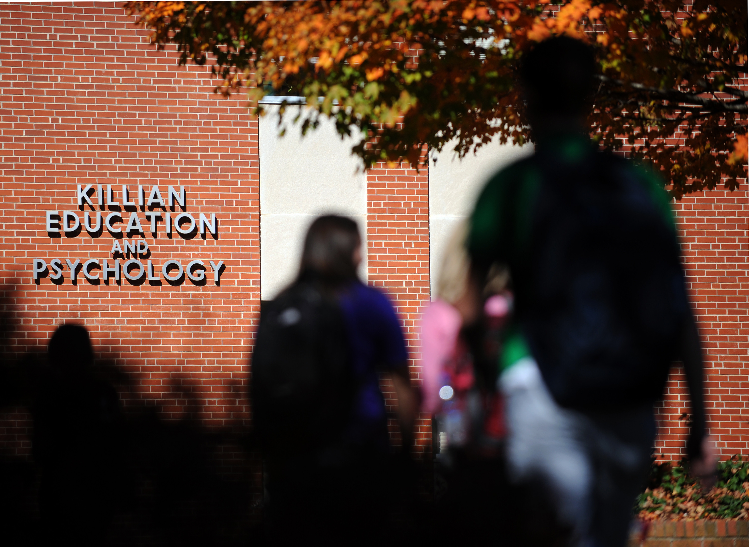 Students walking outside of the Killian Education and Psychology building 