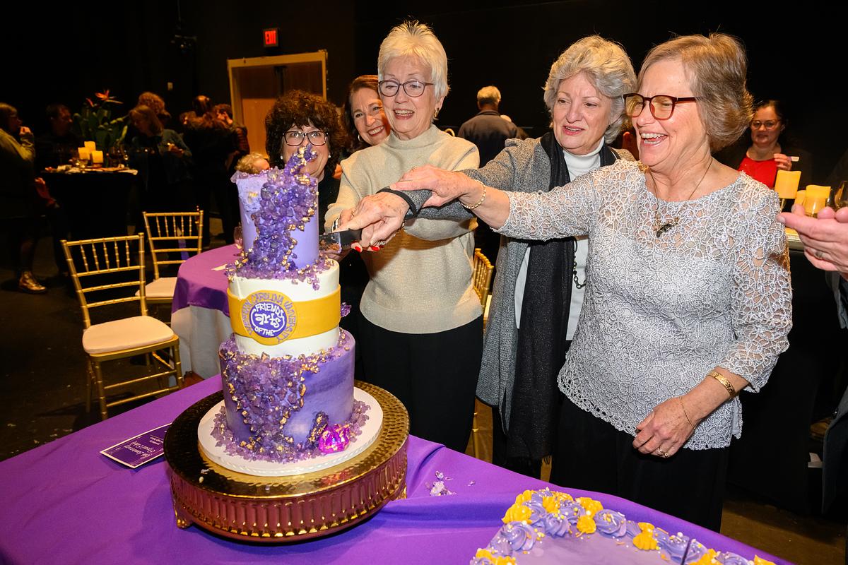 image of FOA members cutting a cake from an FOA event.